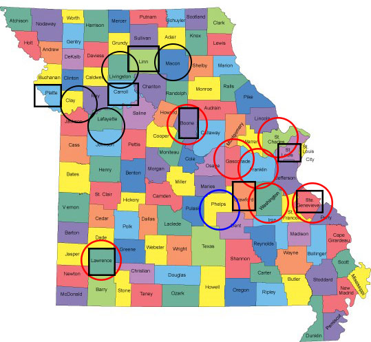 Map of Missouri counties. Black boxes show the counties listed in Table 1 (Linn, Carroll, Platte, Boone, Lawrence, Crawford, St. Louis, Ste. Genevieve). Black circles around Livingston, Macon, Ray, Lafayette counties. Red circles around Boone, Gasconade, Franklin, St. Charles, Washington, Ste. Genevieve, and Lawrence counties. Blue circle around Phelps county.