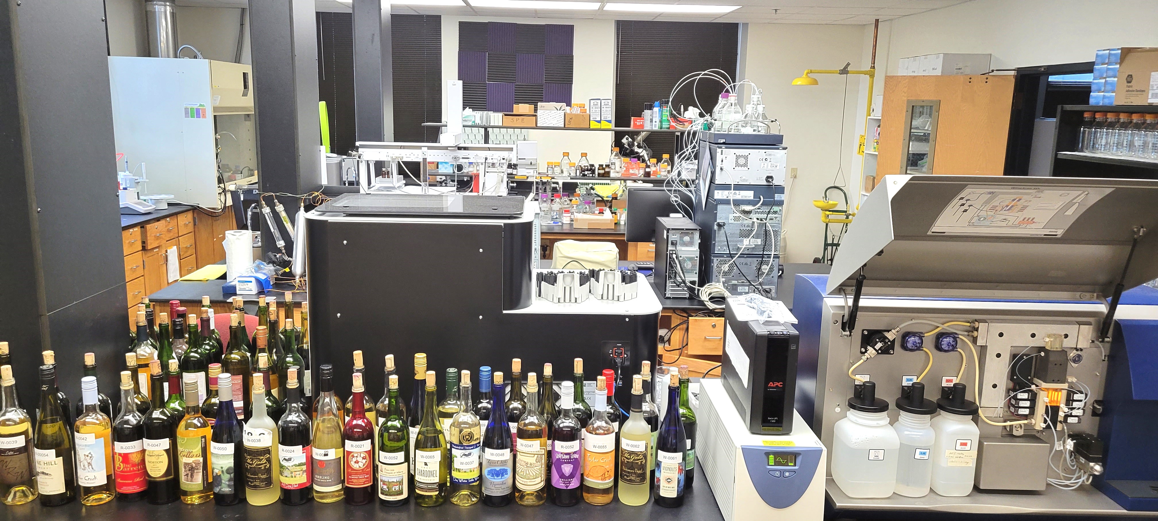 the wine scan machine in the Service Lab with wine bottles lined up next to it